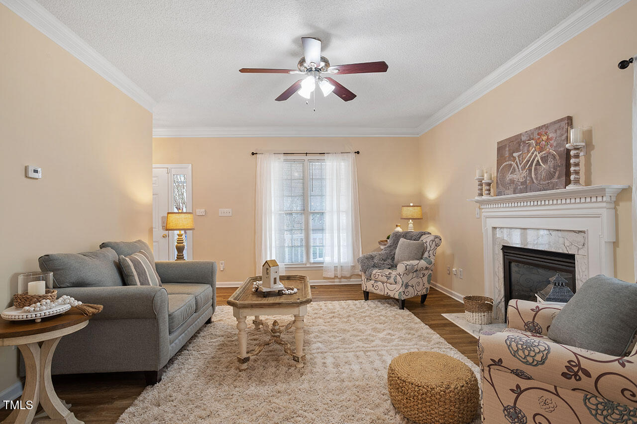 7040 Bellard Court Raleigh, NC 27617 - Photo 6 of 31 a living room with furniture fireplace and window