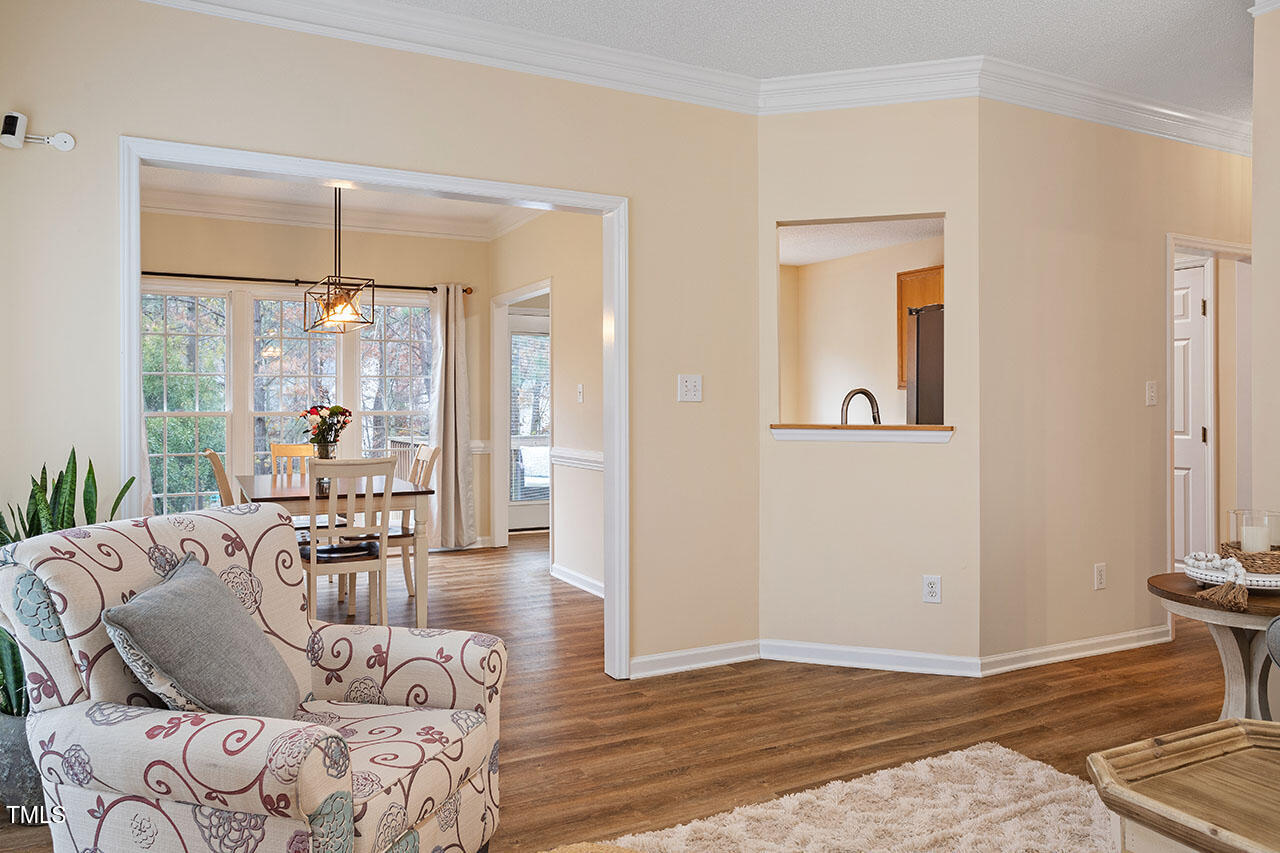 7040 Bellard Court Raleigh, NC 27617 - Photo 7 of 31 a living room with furniture and a large window