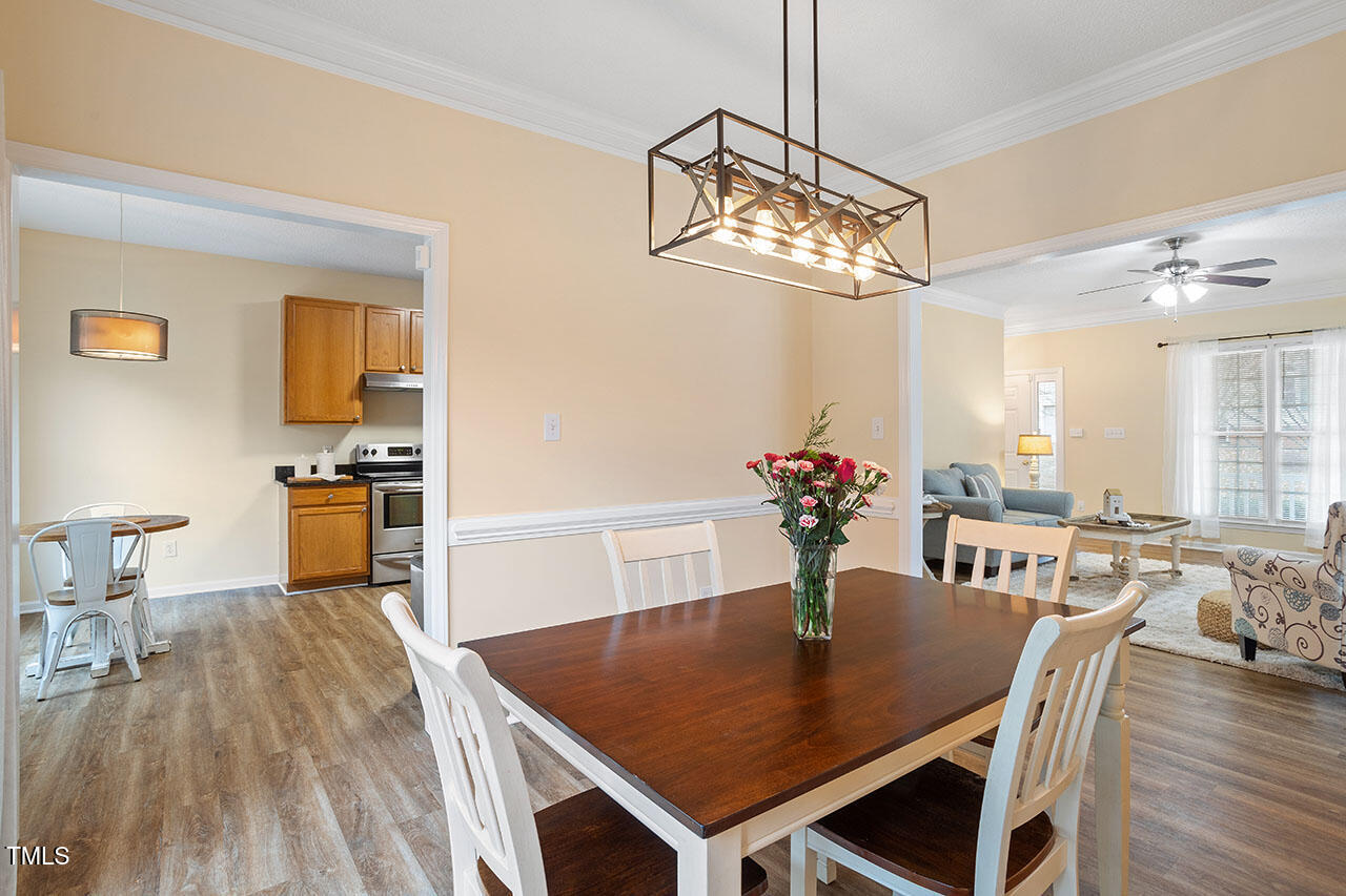 7040 Bellard Court Raleigh, NC 27617 - Photo 10 of 31 a view of a dining room with furniture and wooden floor