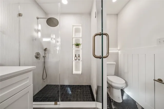 a bathroom with a toilet sink and mirror