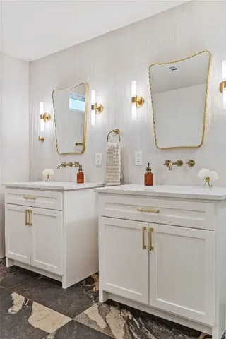 a bathroom with a toilet sink and mirror