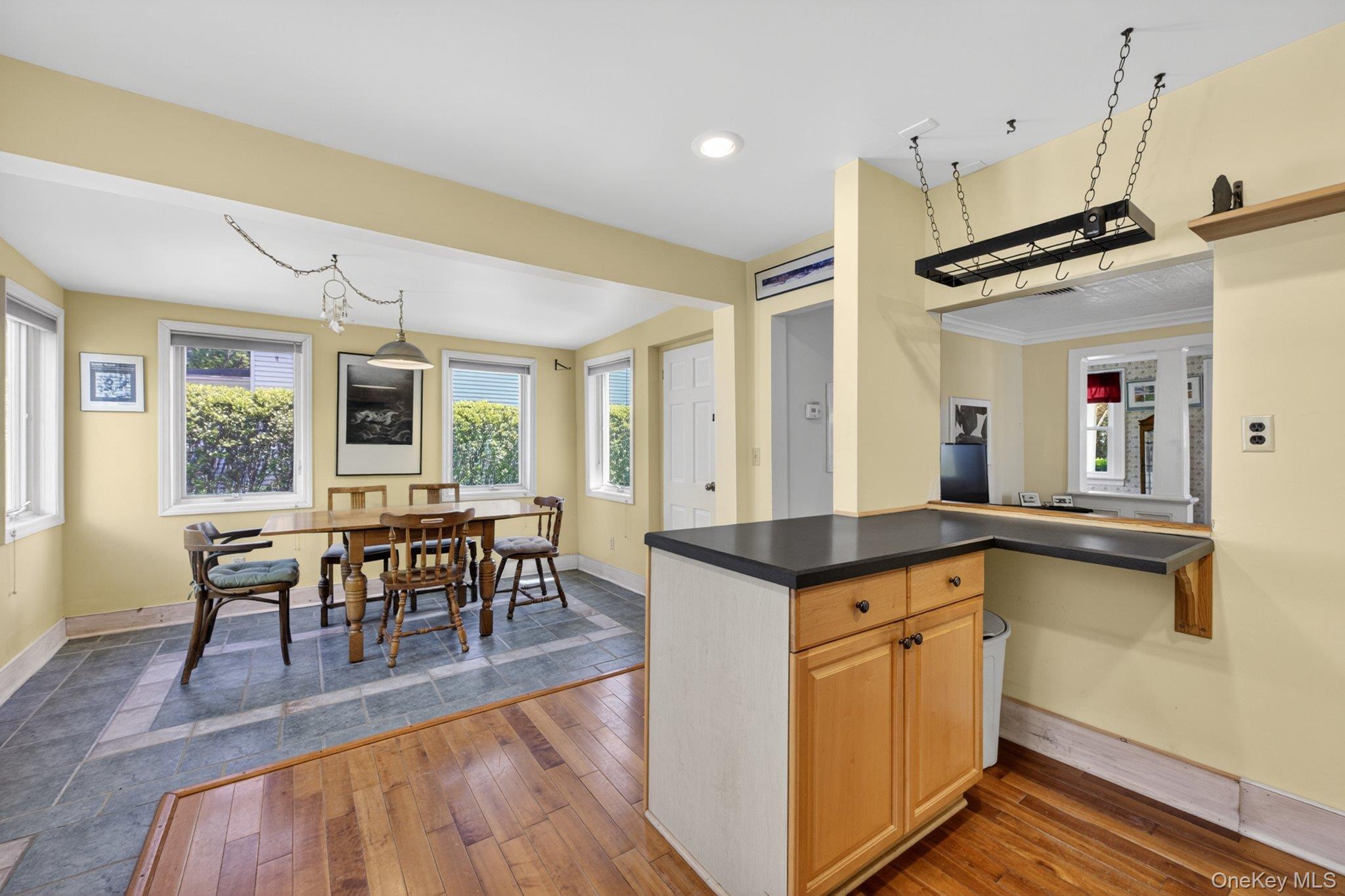 250 Rombout Avenue Beacon, NY 12508 - Photo 12 of 33 a kitchen with granite countertop a stove a sink a dining table and chairs with wooden floor
