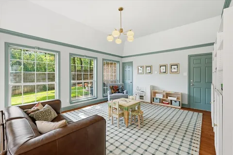 a living room with furniture and floor to ceiling windows