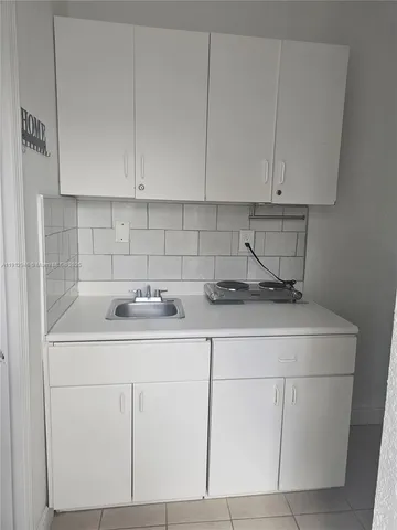 a kitchen with a sink and cabinets
