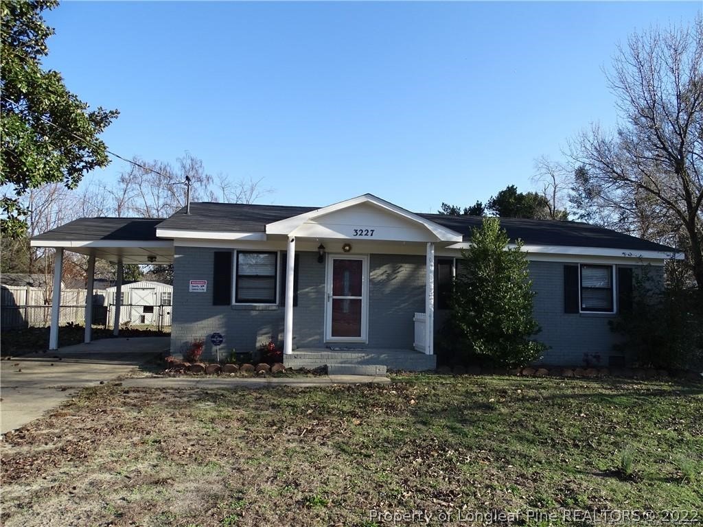 3227 Legion Road Hope Mills, NC 28348 - Photo 1 of 10 a front view of a house with garden