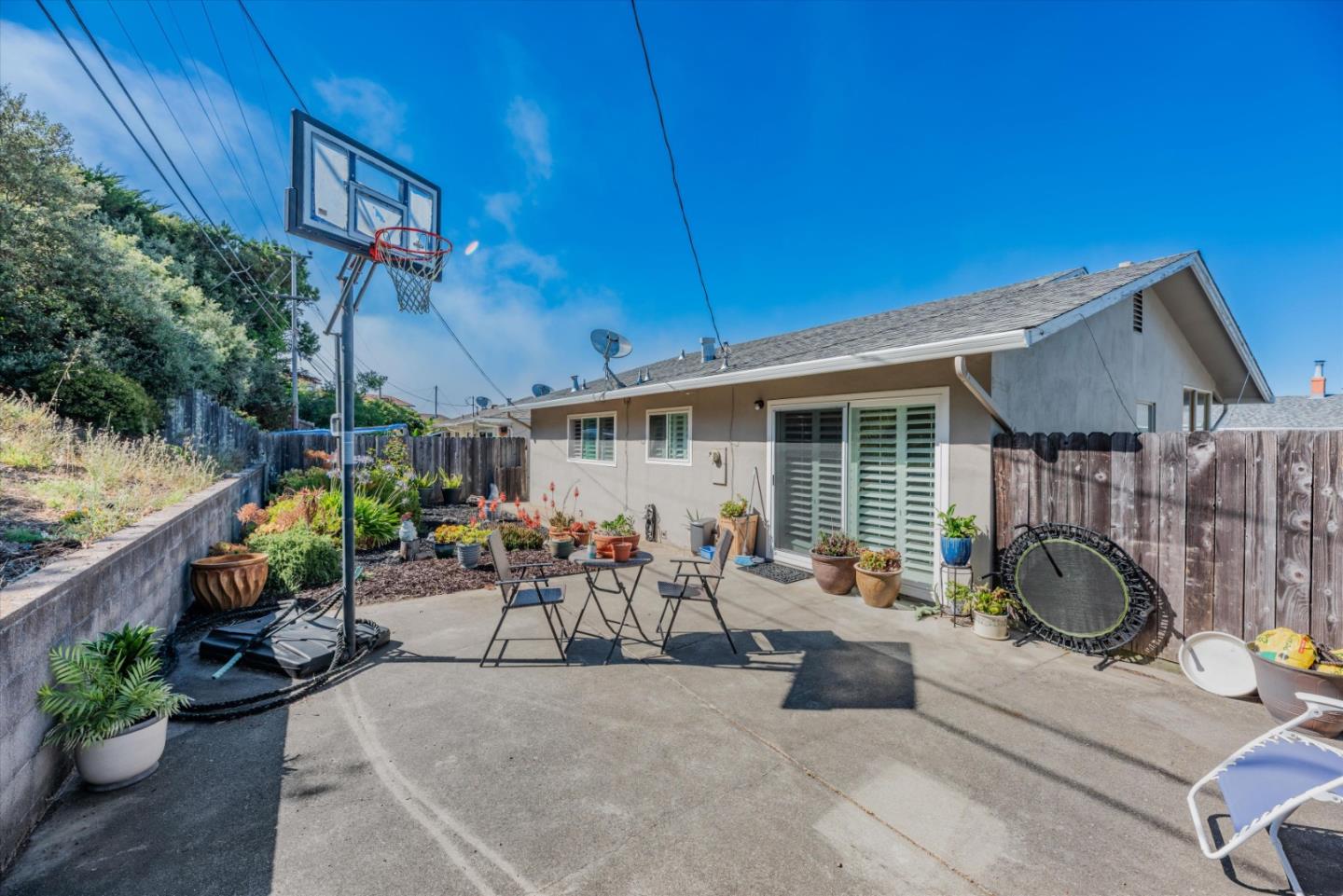 145 Lassen Drive San Bruno, CA 94066 - Photo 28 of 29 a view of a patio with table and chairs potted plants with wooden fence