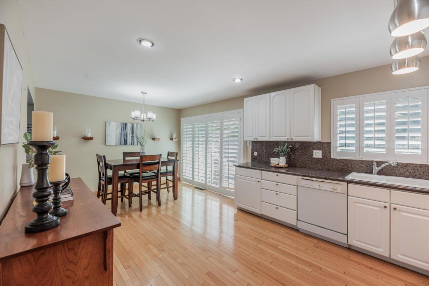 145 Lassen Drive San Bruno, CA 94066 - Photo 8 of 29 a kitchen with stainless steel appliances granite countertop sink cabinets and wooden floor