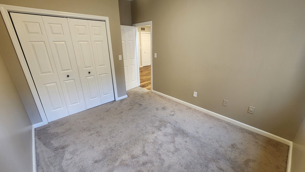 19 Washington Street, Unit 5 Haverhill, MA 01832 - Photo 12 of 17 an empty room with a wooden door