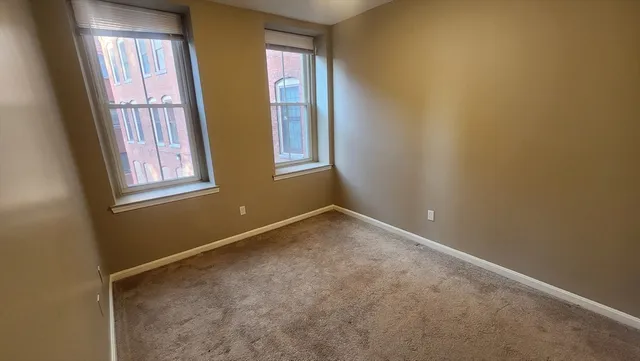 a view of an empty room with windows