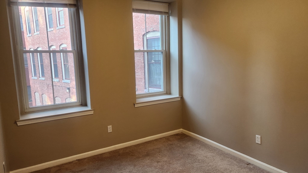 19 Washington Street, Unit 5 Haverhill, MA 01832 - Photo 10 of 17 an empty room with windows