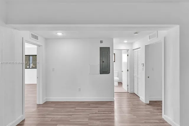a view of a hallway with wooden floor