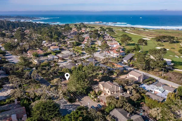 an aerial view of residential building with parking and yard