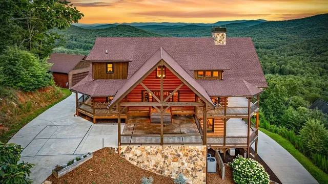 a aerial view of a house with swimming pool next to a yard