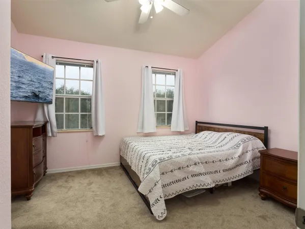 a bed sitting in a room next to a window