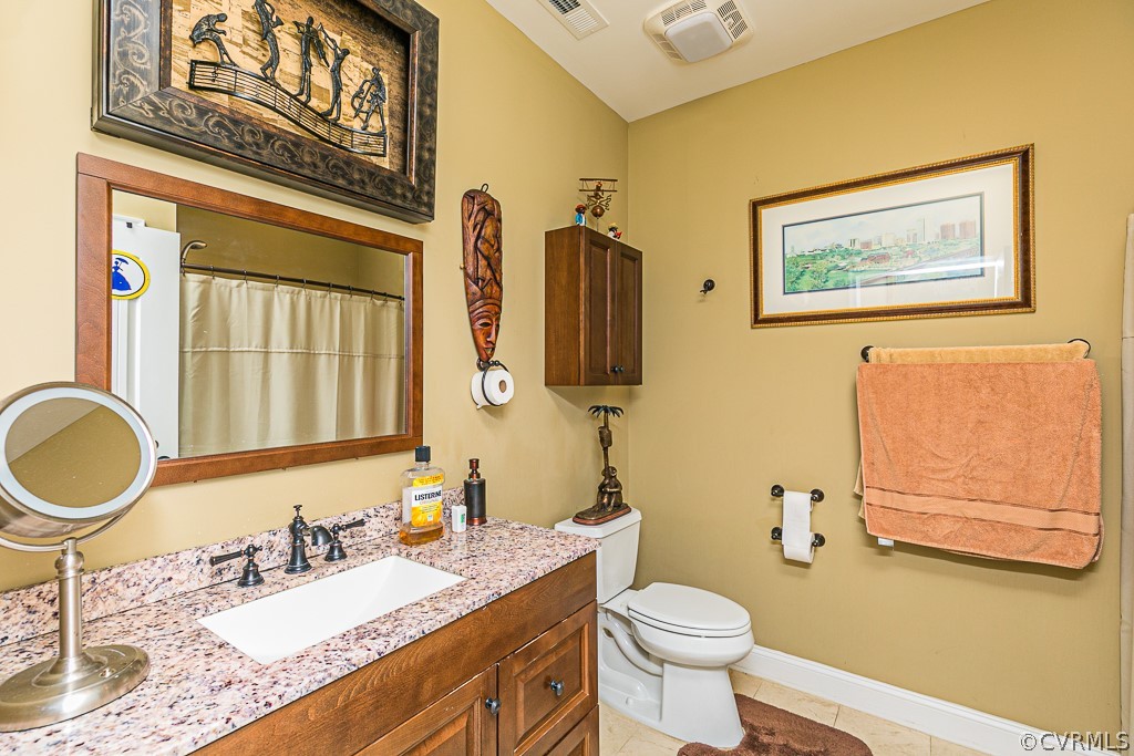 1982 Mountain Road Glen Allen, VA 23060 - Photo 34 of 49 a bathroom with a granite countertop toilet sink and mirror