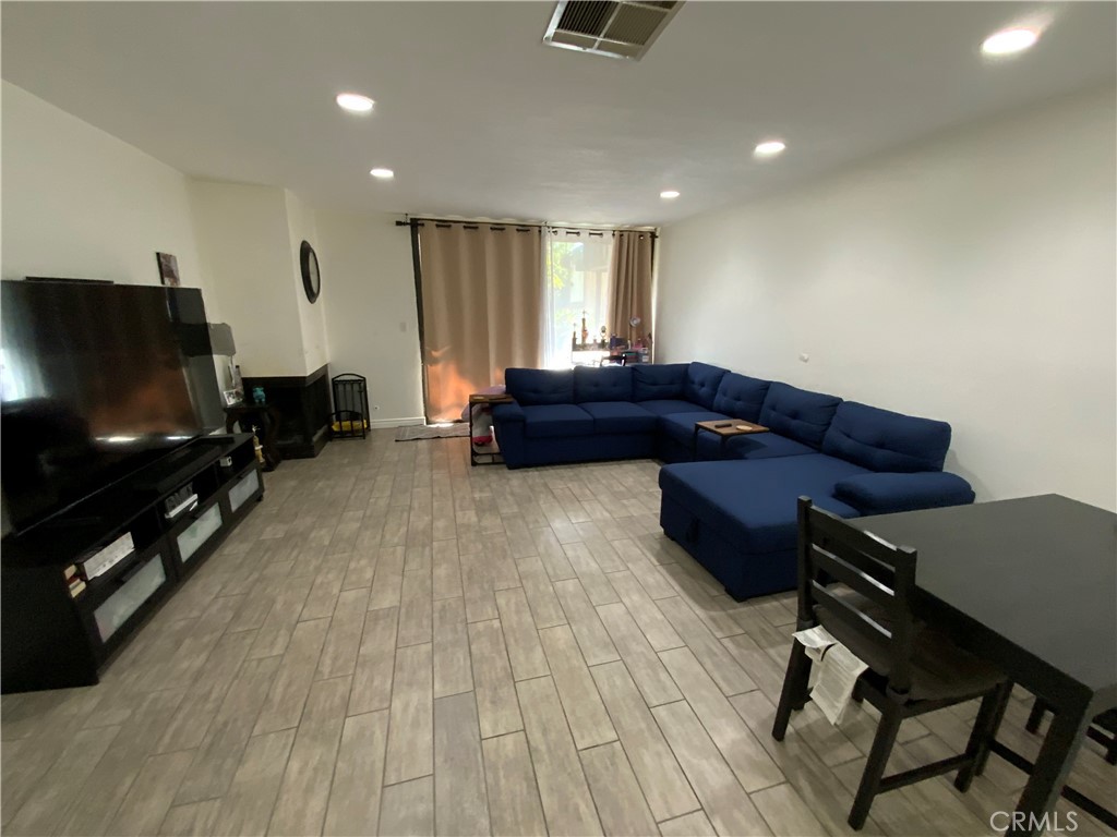 4140 Workman Mill Road, Unit 172 Whittier, CA 90601 - Photo 5 of 21 a living room with furniture and a flat screen tv