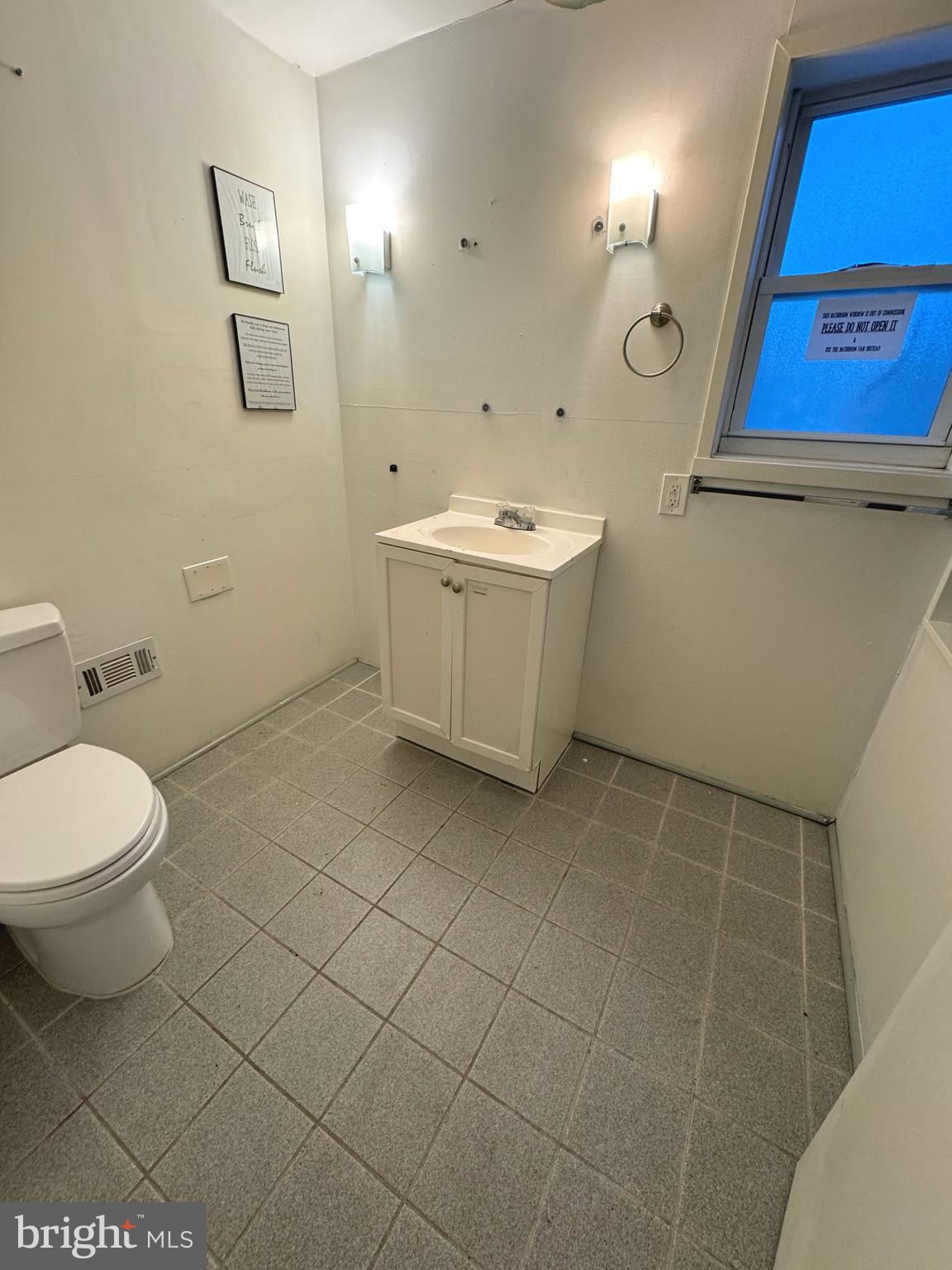 918 Ramsay Street Baltimore, MD 21223 - Photo 18 of 19 a bathroom with a toilet sink and mirror