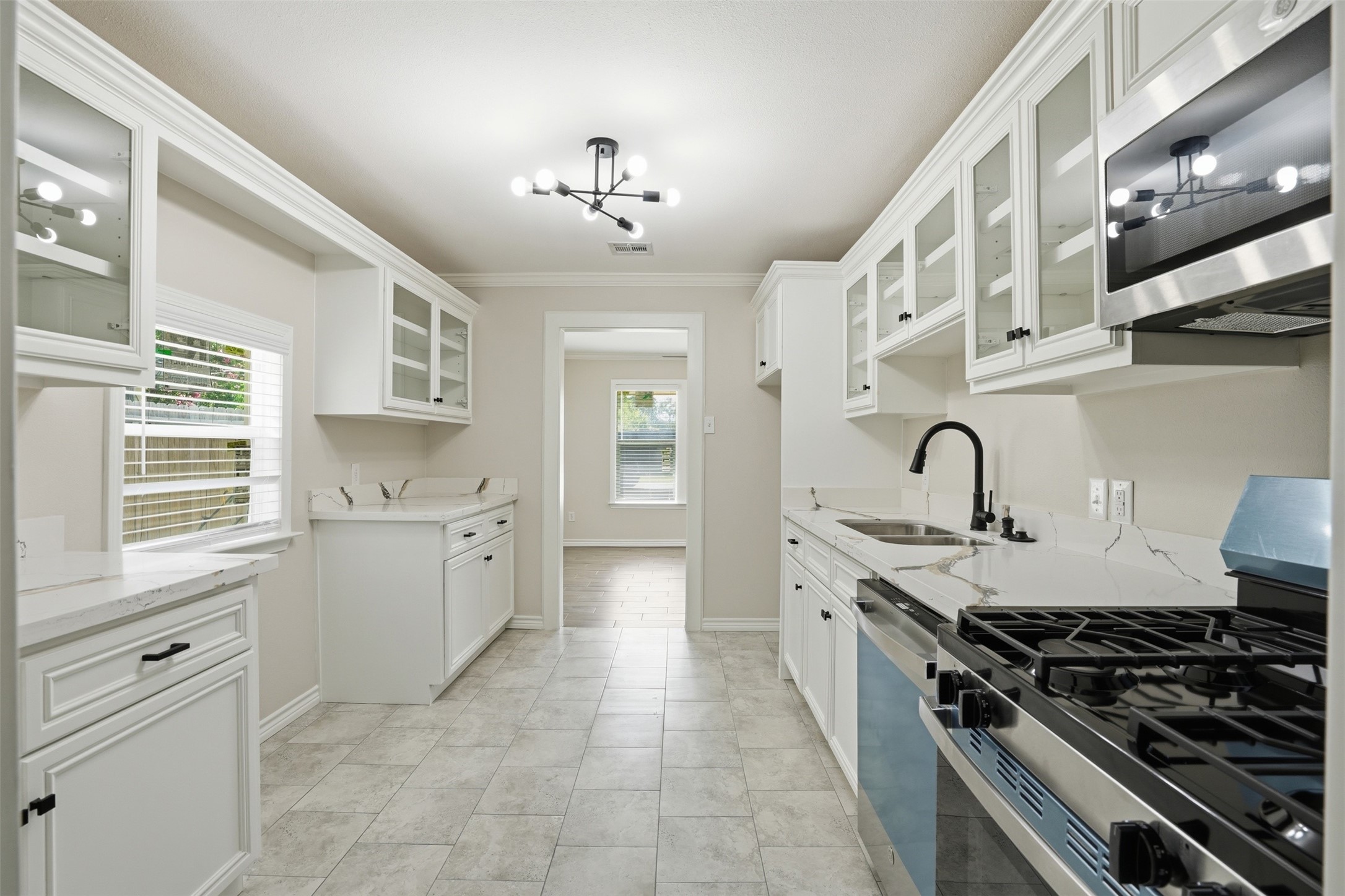 6518 Paris Street Houston, TX 77021 - Photo 12 of 23 a large kitchen with stainless steel appliances granite countertop a stove and a sink