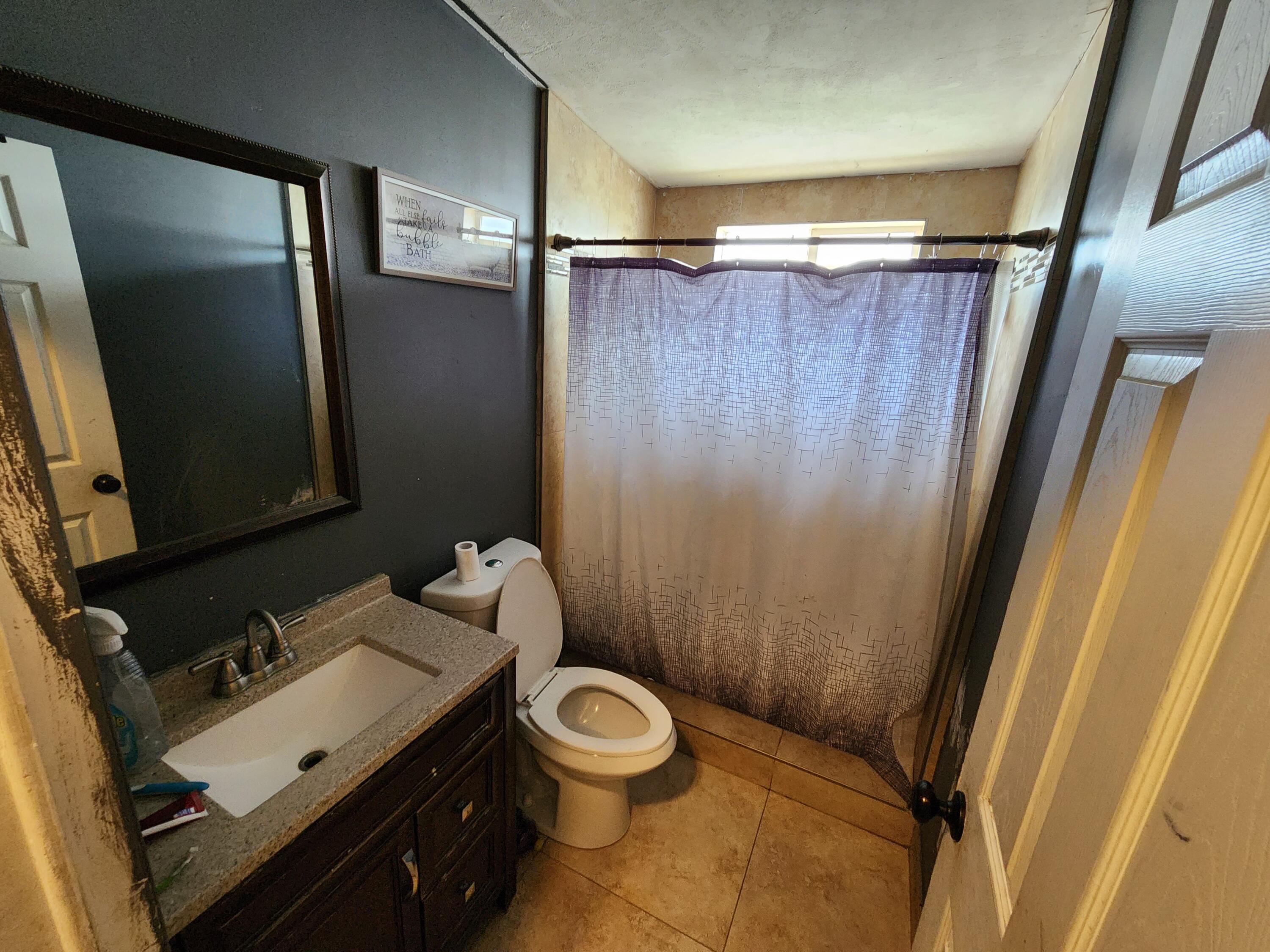 79550 Ave 40, Unit 5 Indio, CA 92203 - Photo 5 of 6 a bathroom with a sink and a mirror