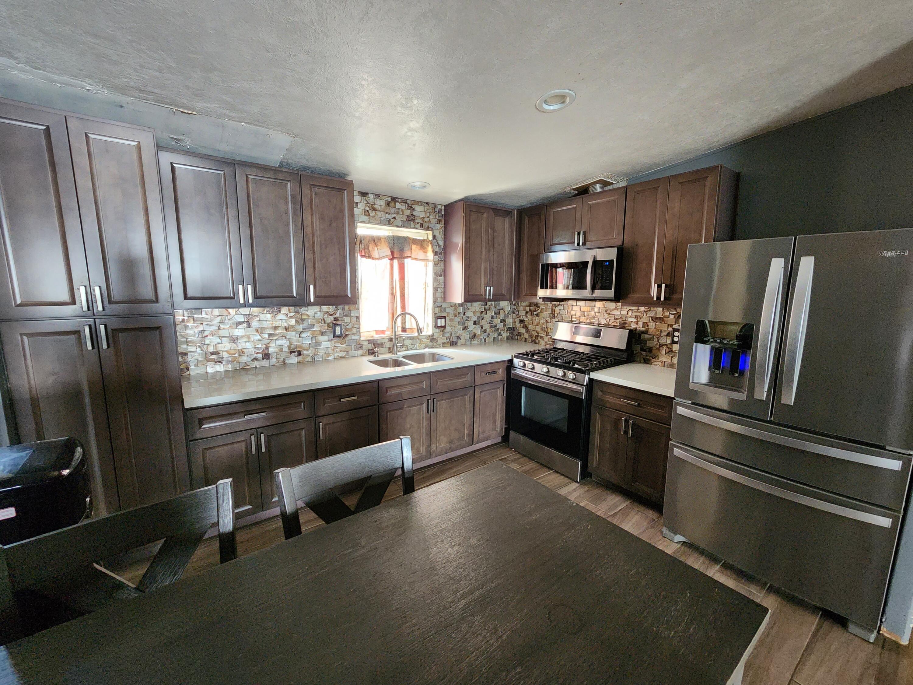 79550 Ave 40, Unit 5 Indio, CA 92203 - Photo 6 of 6 a kitchen with a refrigerator stove and microwave