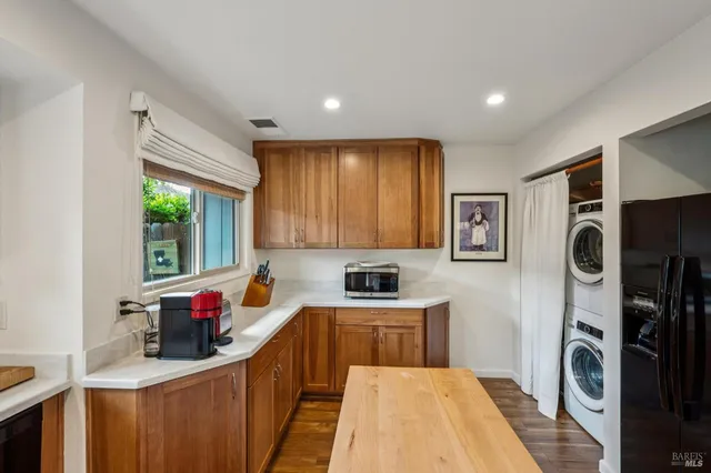 a kitchen that has a sink cabinets counter space and a window