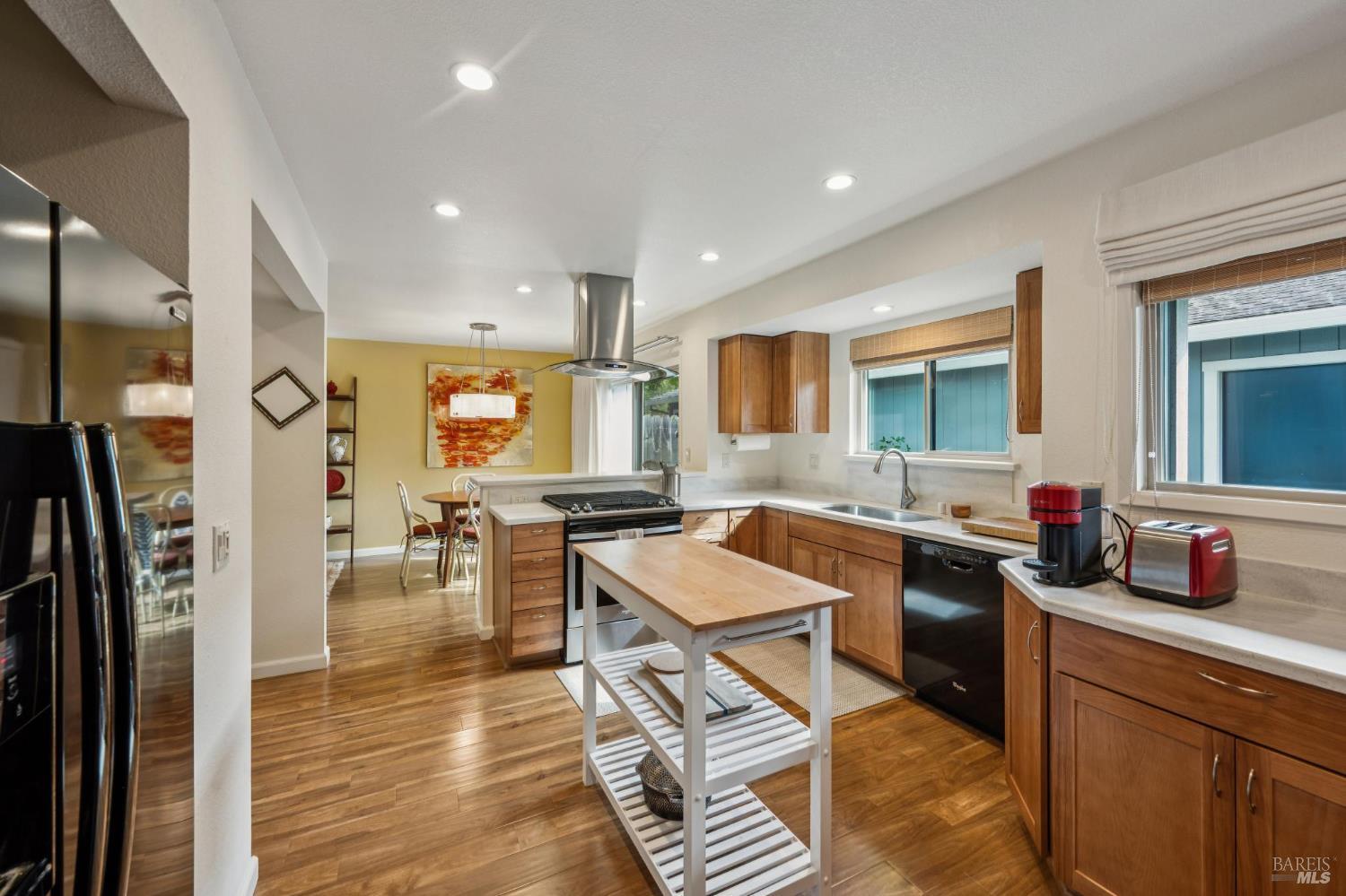 19167 Robinson Road, Unit Y Sonoma, CA 95476 - Photo 13 of 32 a kitchen with a table chairs refrigerator and cabinets