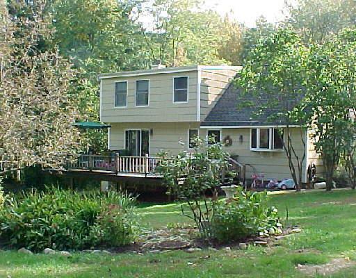 192 Crane Hollow Road Bethlehem, CT 06751 - Photo 1 of 1 a front view of a house with a garden