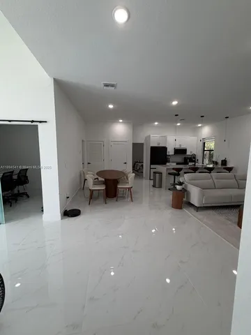 a living room with furniture and a mirror