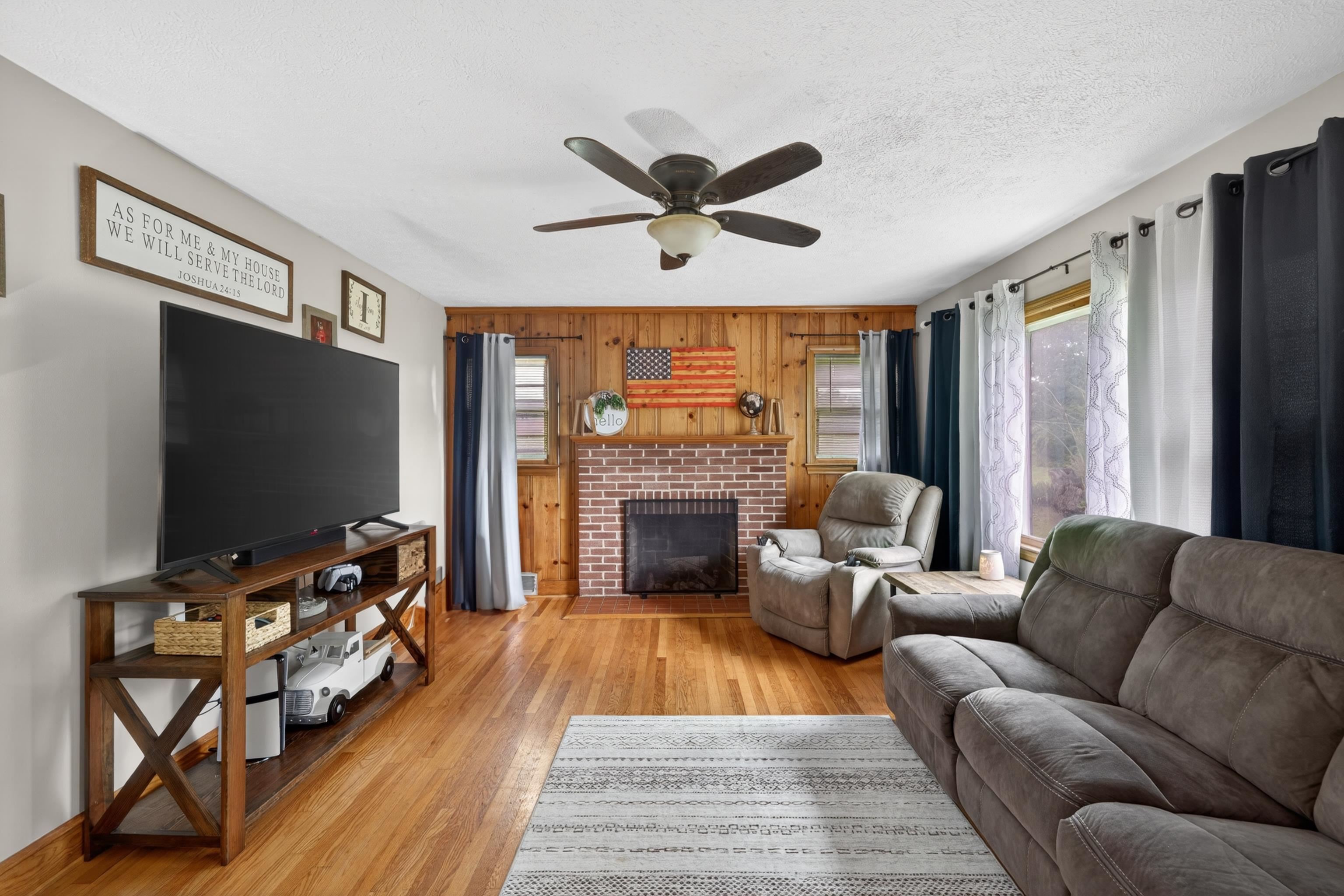 7827 Lee Highway Raphine, VA 24472 - Photo 11 of 62 a living room with furniture a flat screen tv and a fireplace