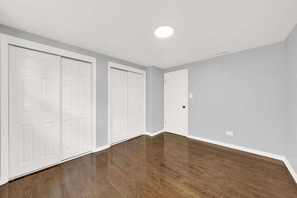 7245 South Washtenaw Avenue, Unit 1 Chicago, IL 60629 - Photo 13 of 14 a view of an empty room with wooden floor