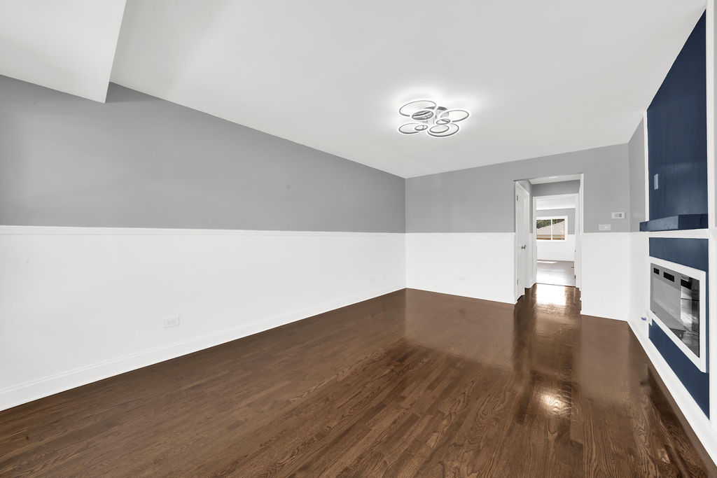 7245 South Washtenaw Avenue, Unit 1 Chicago, IL 60629 - Photo 2 of 14 a view of empty room with wooden floor