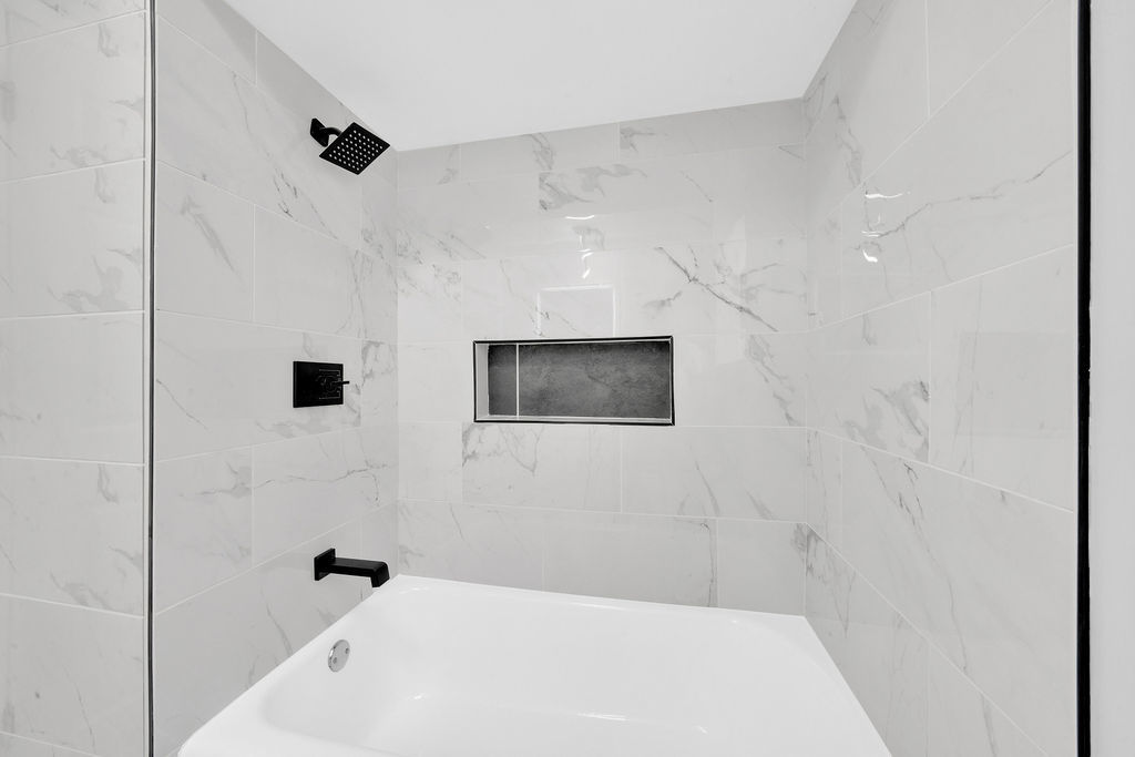 7245 South Washtenaw Avenue, Unit 1 Chicago, IL 60629 - Photo 5 of 14 a bathroom with a bathtub and a shower