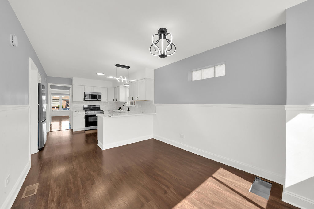7245 South Washtenaw Avenue, Unit 1 Chicago, IL 60629 - Photo 9 of 14 a view of a kitchen with wooden floor and a kitchen