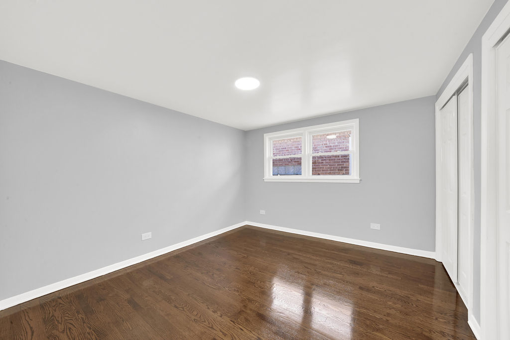 7245 South Washtenaw Avenue, Unit 1 Chicago, IL 60629 - Photo 10 of 14 a view of a big room with wooden floor and windows in a room