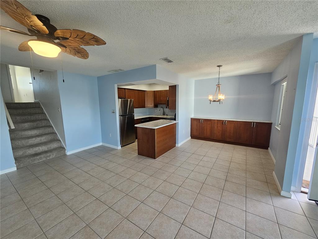 14800 Walsingham Road, Unit 1215 Largo, FL 33774 - Photo 9 of 26 a kitchen with granite countertop a sink and cabinets