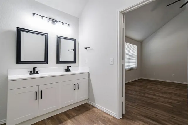 a bathroom with 2 sink and a mirror