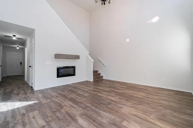 a view of an empty room with a fireplace and a window