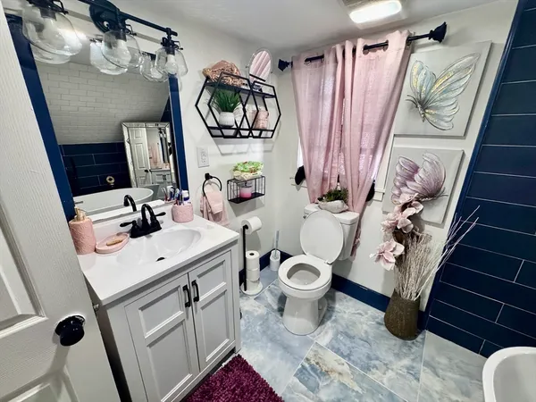 a bathroom with a sink toilet and shower