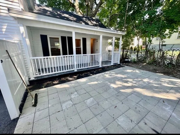 a view of a house with wooden fence