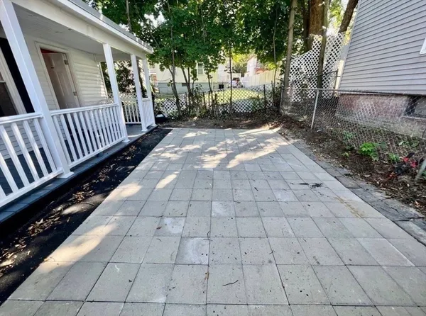 a view of a backyard with pathway