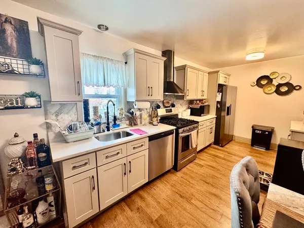 a kitchen with a sink stove and wooden cabinets
