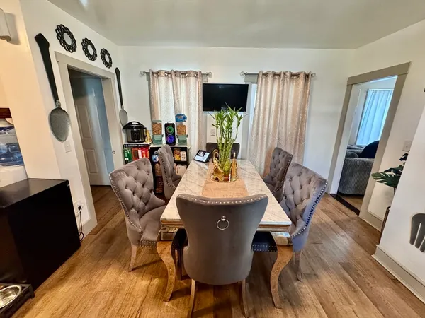 a view of a dining room with furniture window and wooden floor