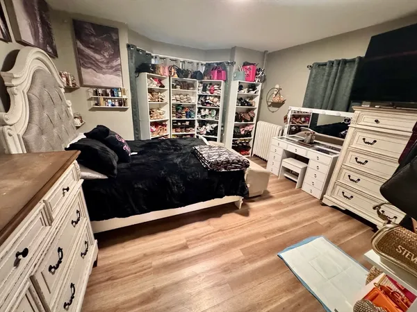 a bedroom with furniture and a flat screen tv