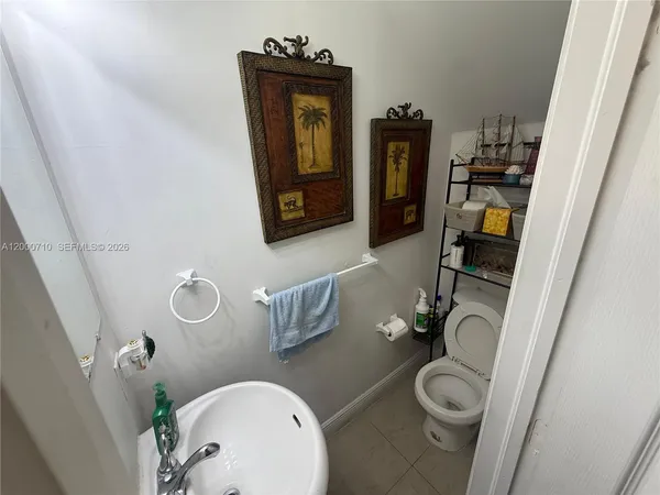 a bathroom with a toilet and a mirror