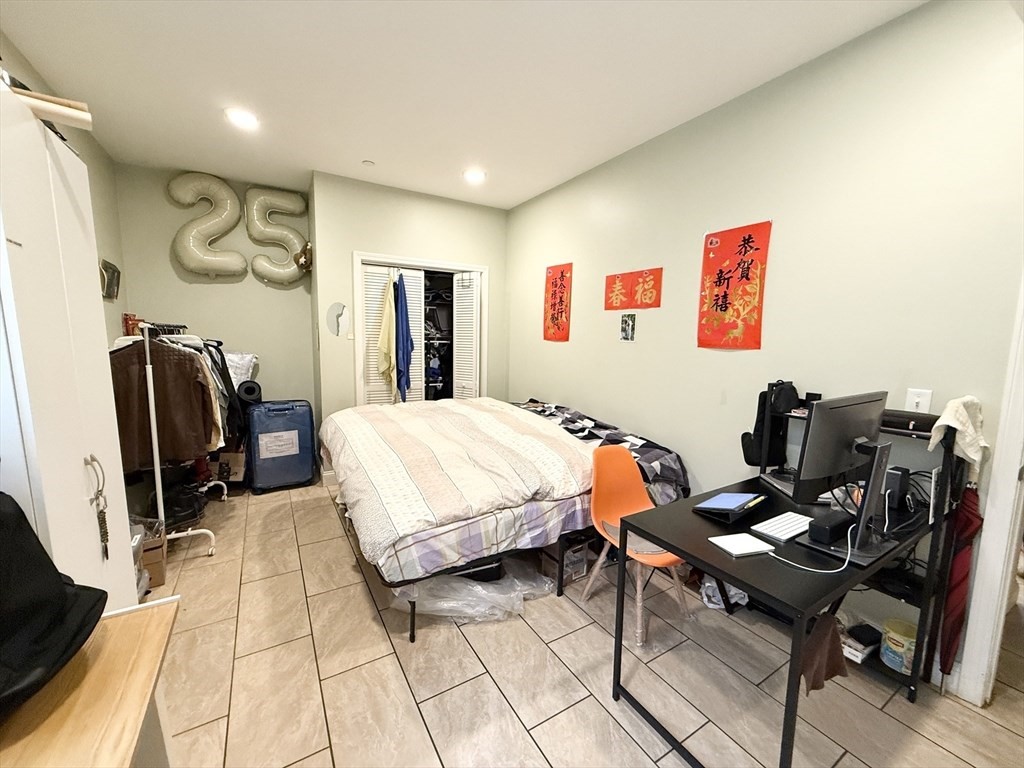 299 Dudley Street, Unit 2 Boston, MA 02119 - Photo 2 of 6 a bedroom with a bed and furniture