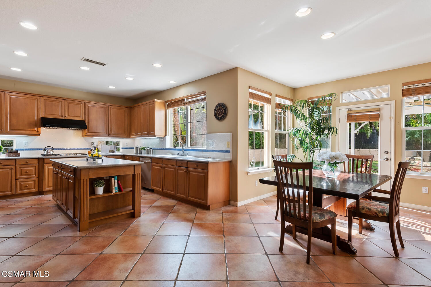 569 Rustic Hills Drive Simi Valley, CA 93065 - Photo 14 of 59 a kitchen with a stove a sink a dining table and chairs