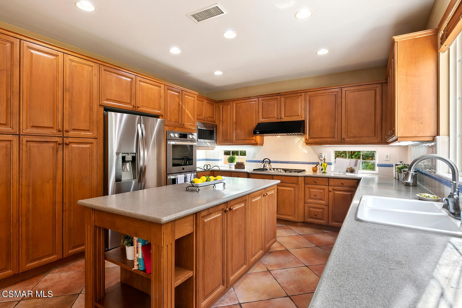 569 Rustic Hills Drive Simi Valley, CA 93065 - Photo 16 of 59 a kitchen with stainless steel appliances granite countertop a refrigerator a sink dishwasher and a stove