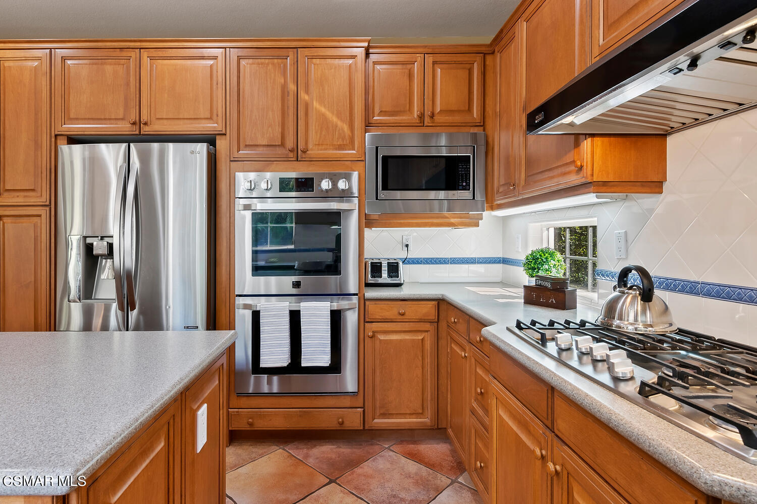 569 Rustic Hills Drive Simi Valley, CA 93065 - Photo 17 of 59 a kitchen with stainless steel appliances granite countertop a stove a sink and a microwave
