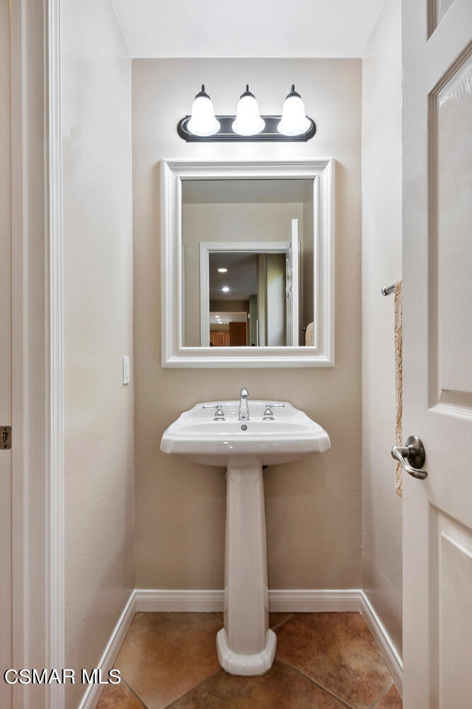 569 Rustic Hills Drive Simi Valley, CA 93065 - Photo 23 of 59 a bathroom with a sink and a mirror