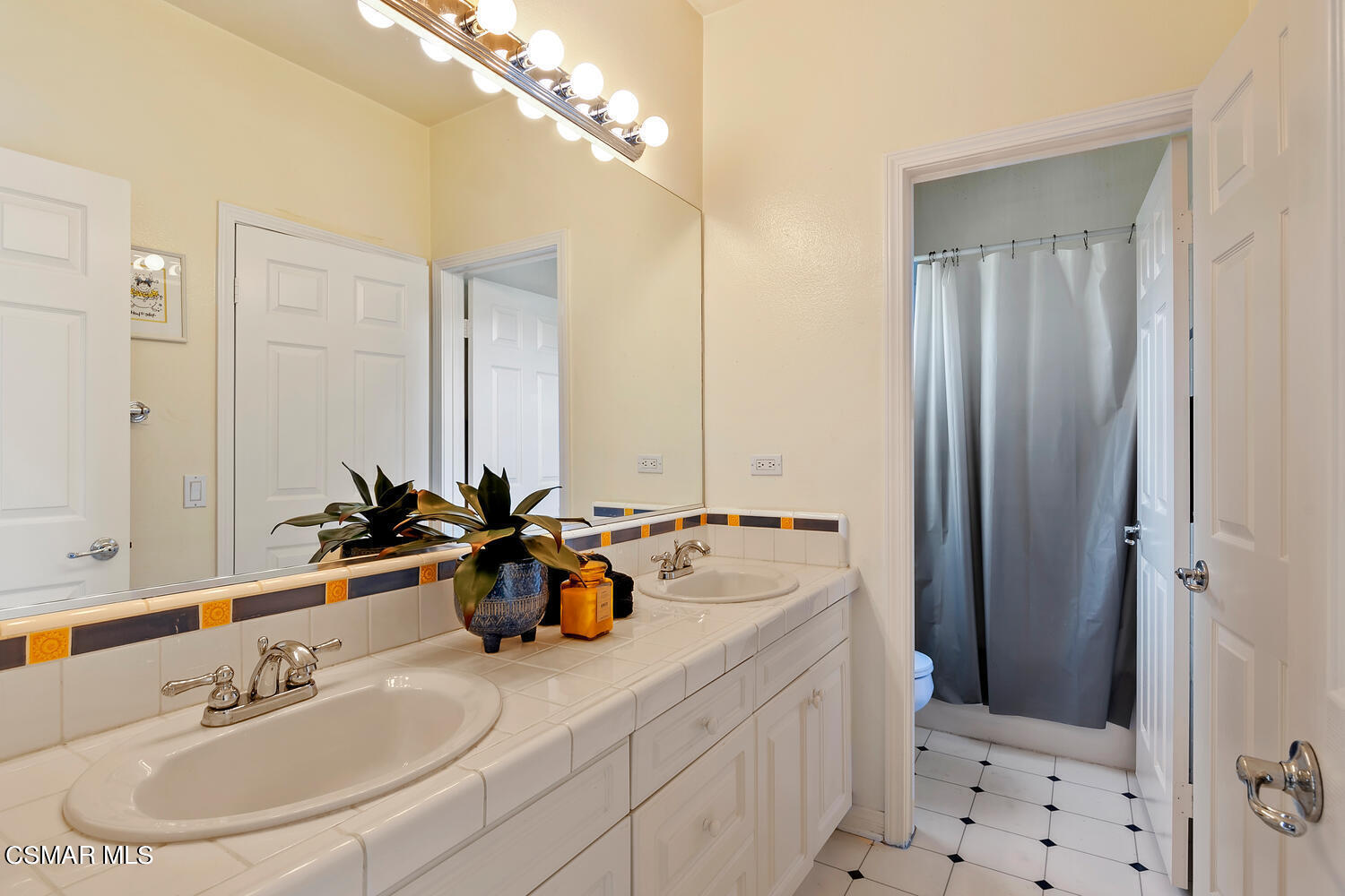 569 Rustic Hills Drive Simi Valley, CA 93065 - Photo 33 of 59 a bathroom with double vanity sinks and a mirror